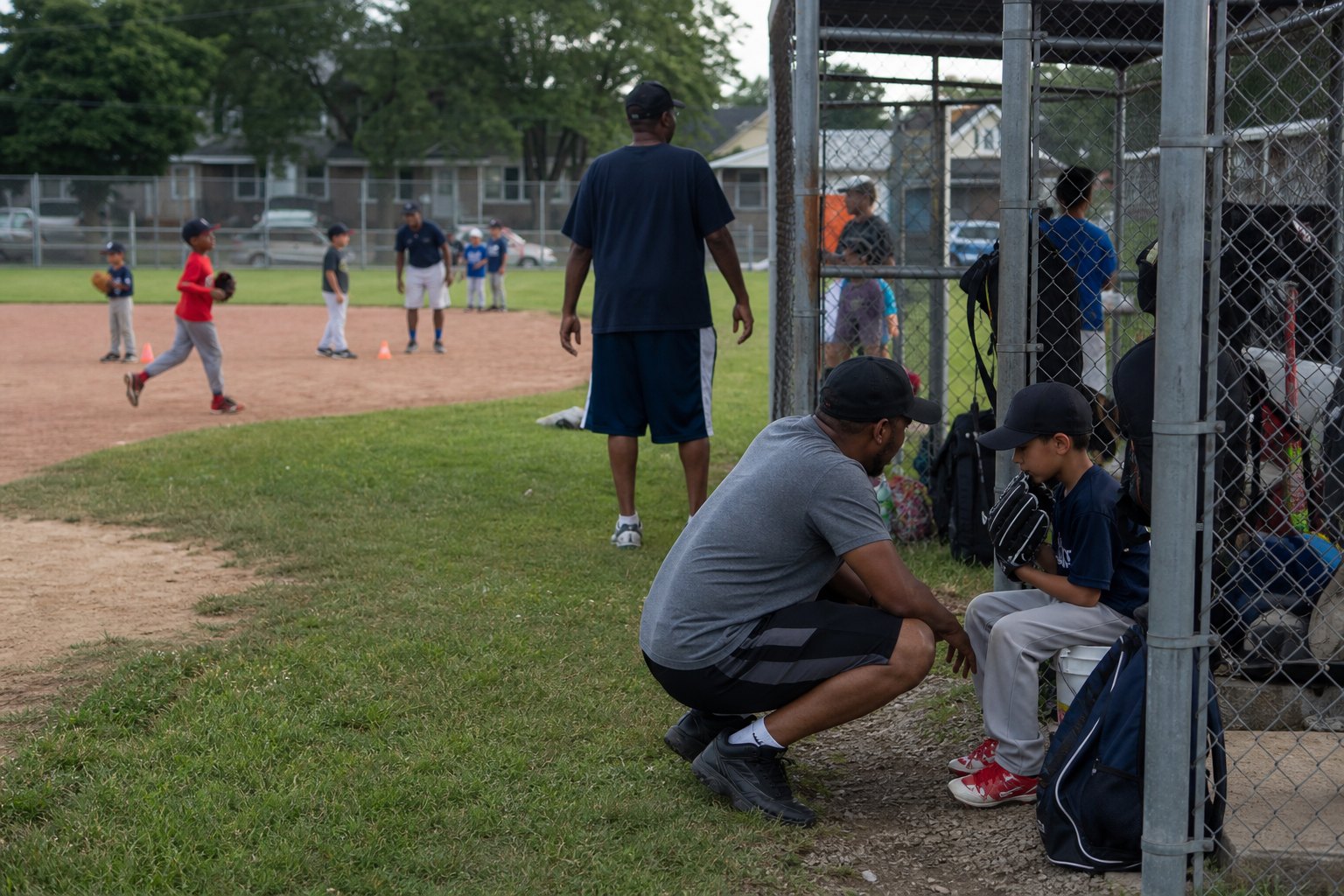 Chicago Heights coaches mentoring children at summer baseball practice