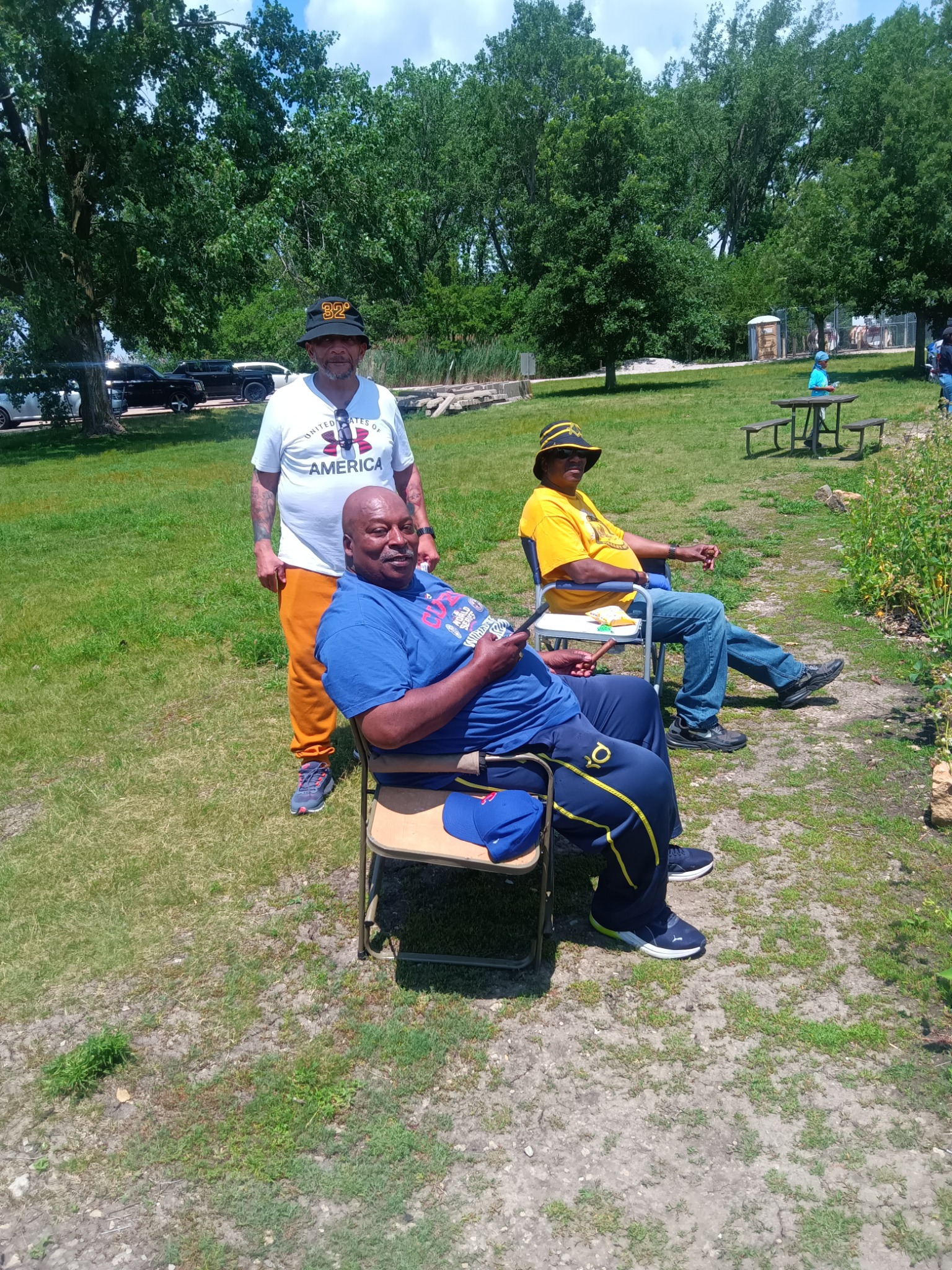 Young people learning fishing skills with adult volunteers